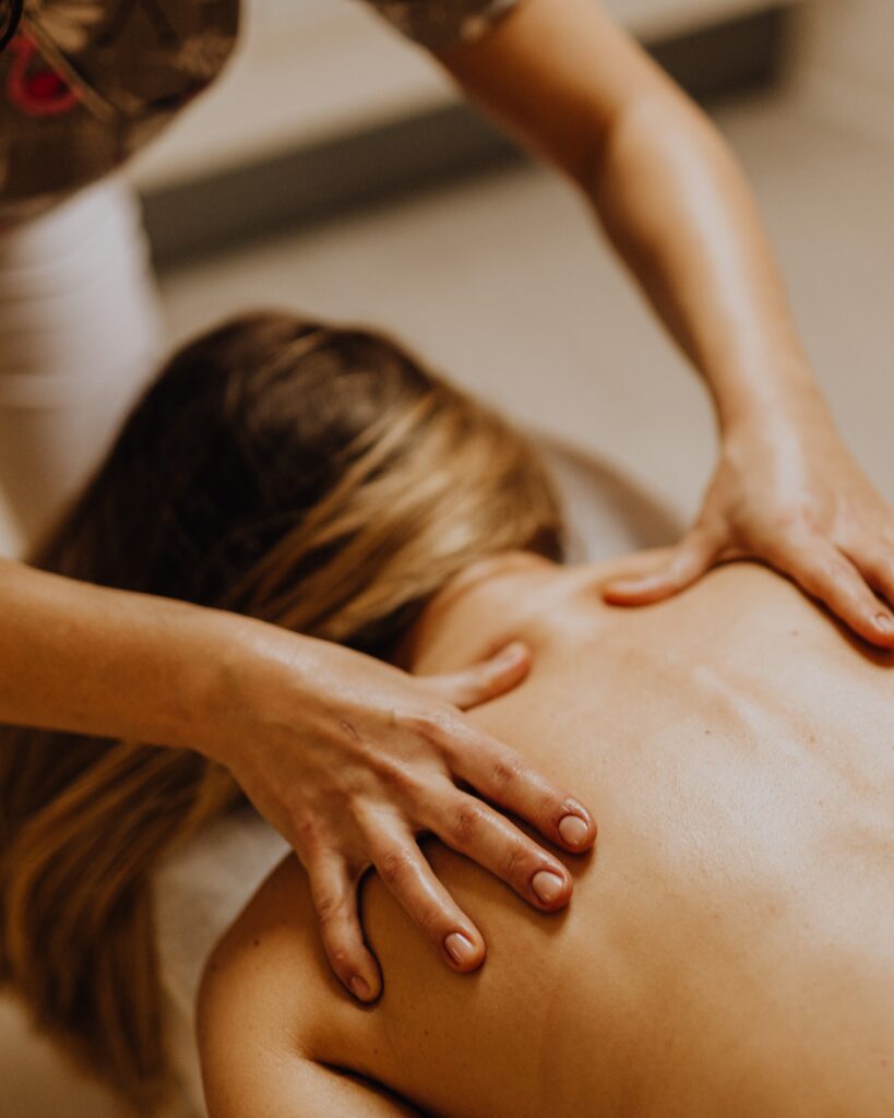 Hands massaging someone's back